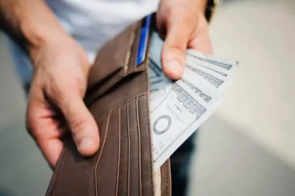 man taking money from wallet